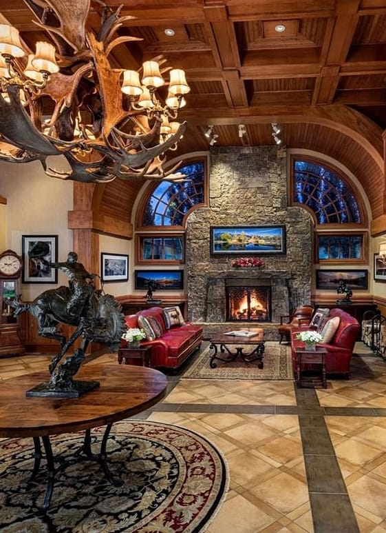 A room with a fireplace and a statue of a horse