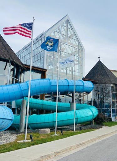 A blue water slide outside of a building