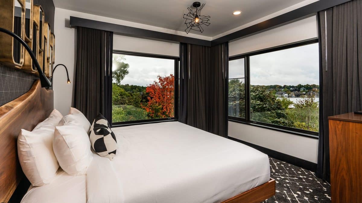 A bed with a window in a room