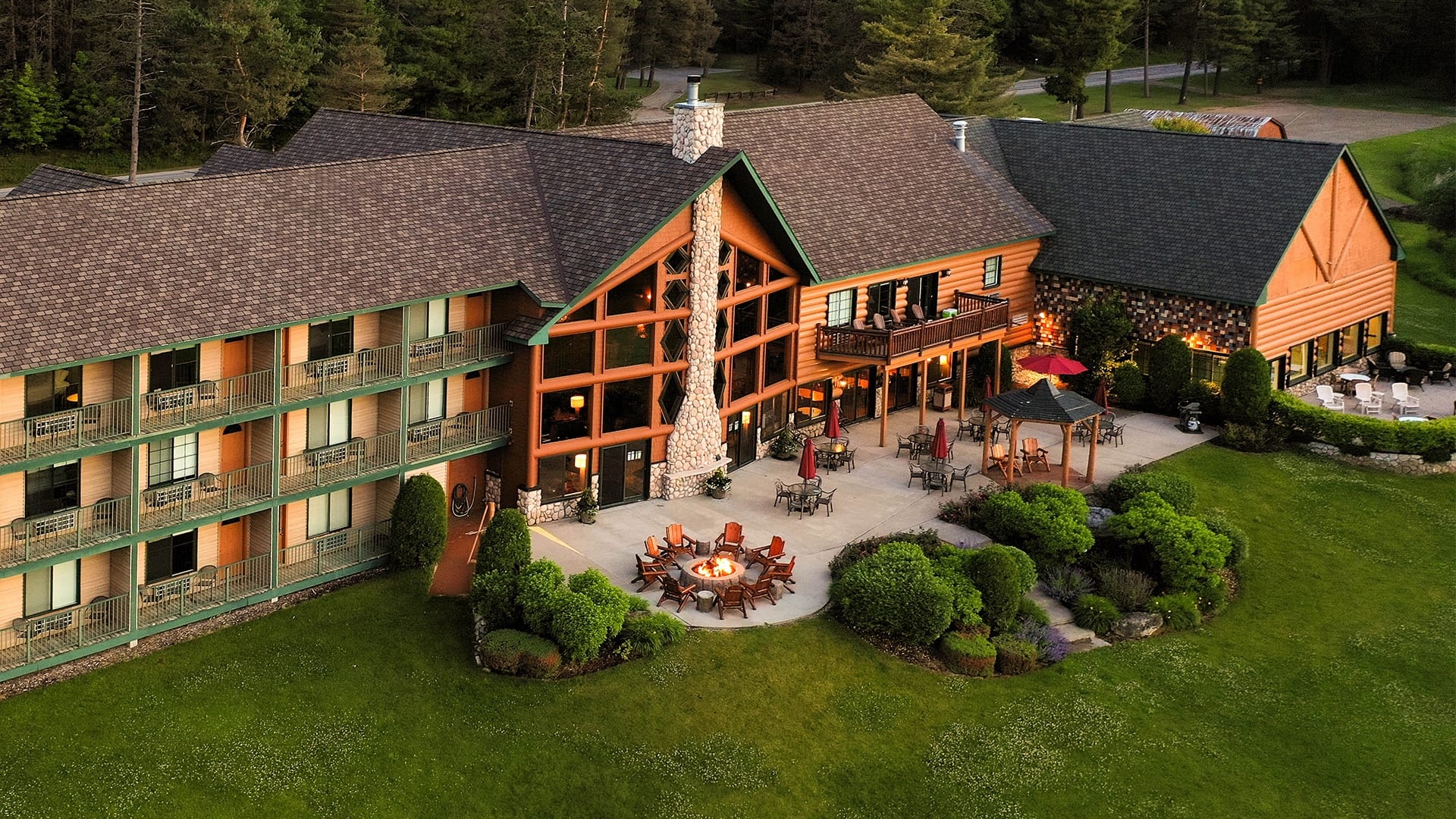 A building with a fire pit and trees