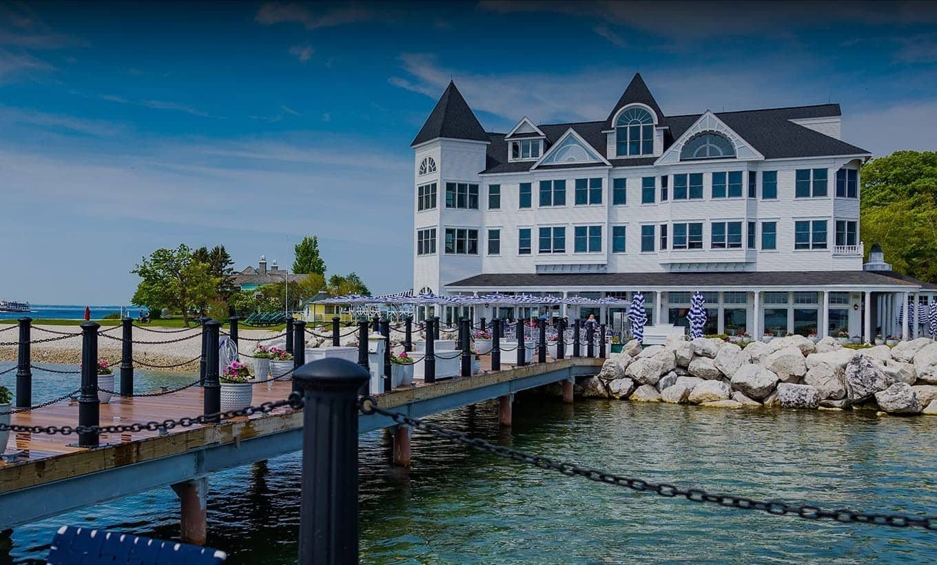 A dock with chairs and a building in the background