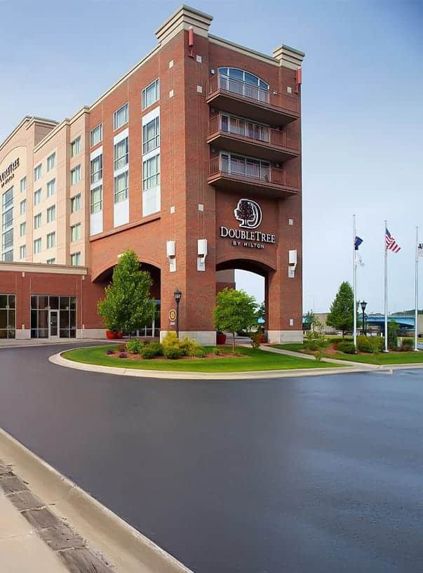 A building with a parking lot and flags