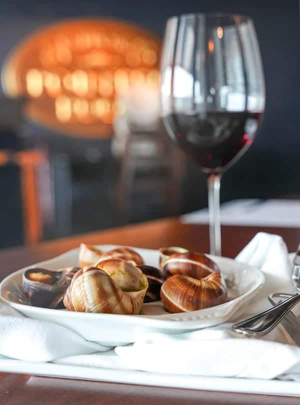 A plate of snails and a glass of wine