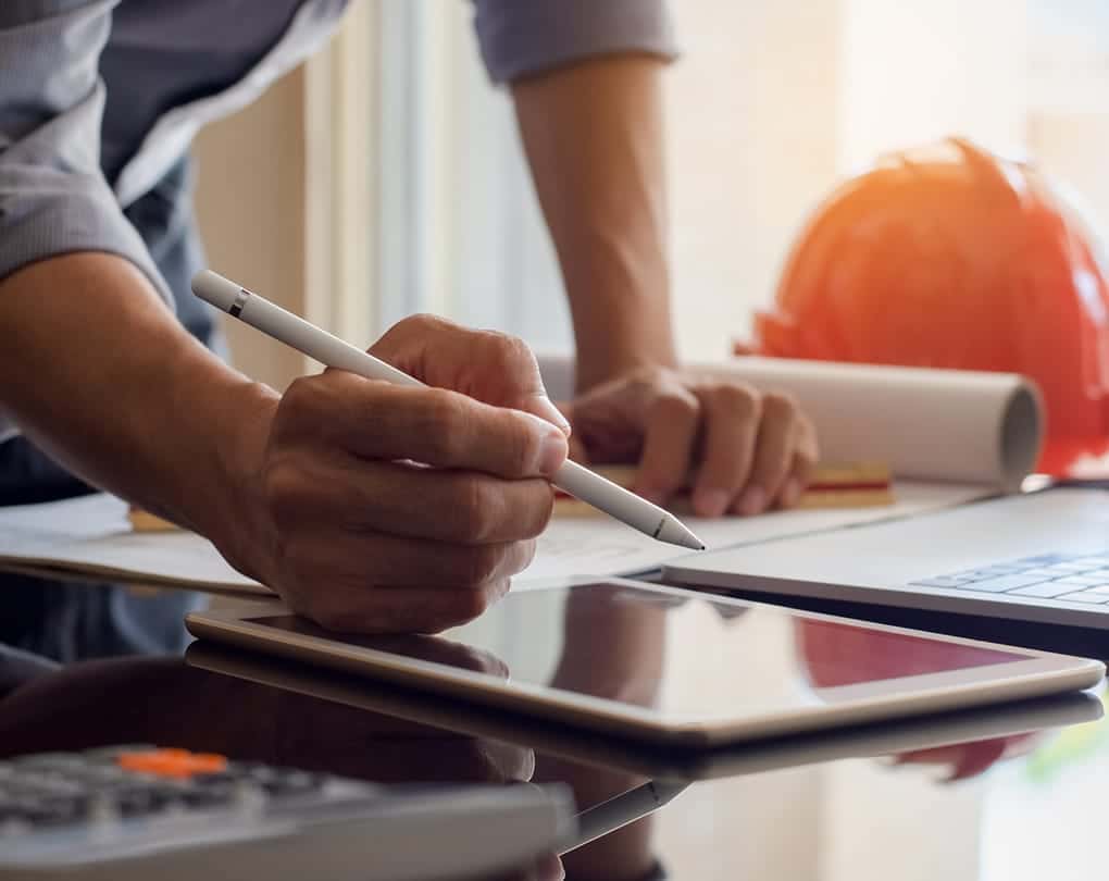 A person holding a stylus and pen