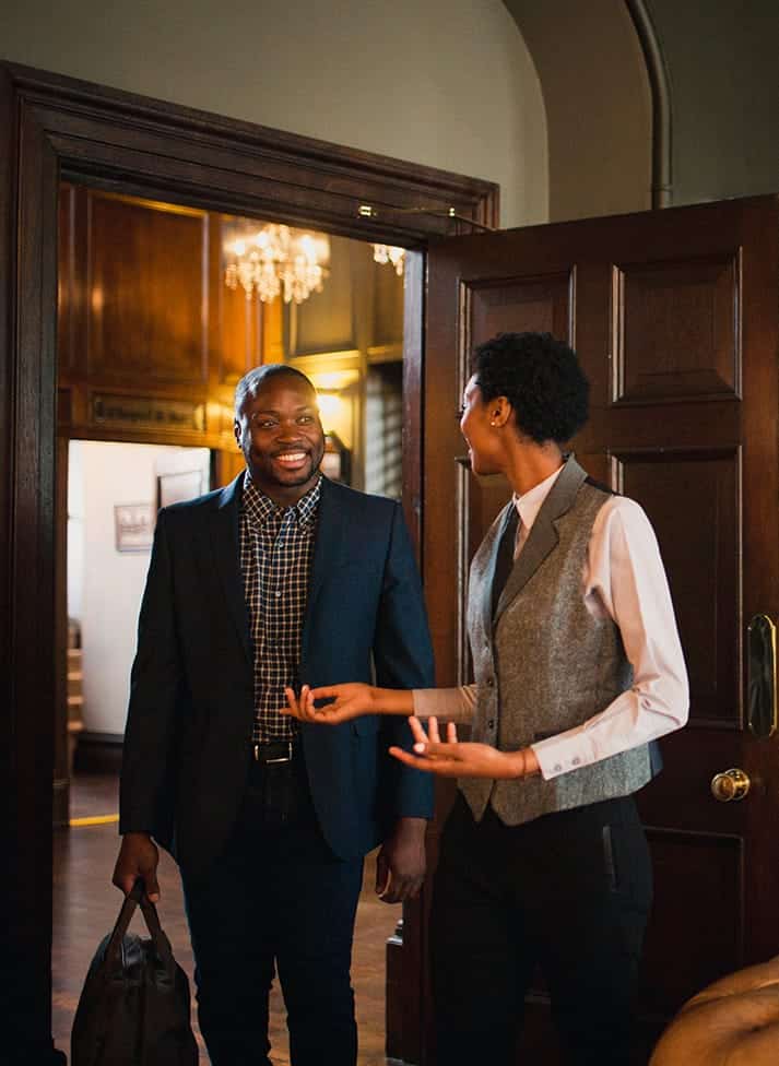 A man and woman standing in front of a door