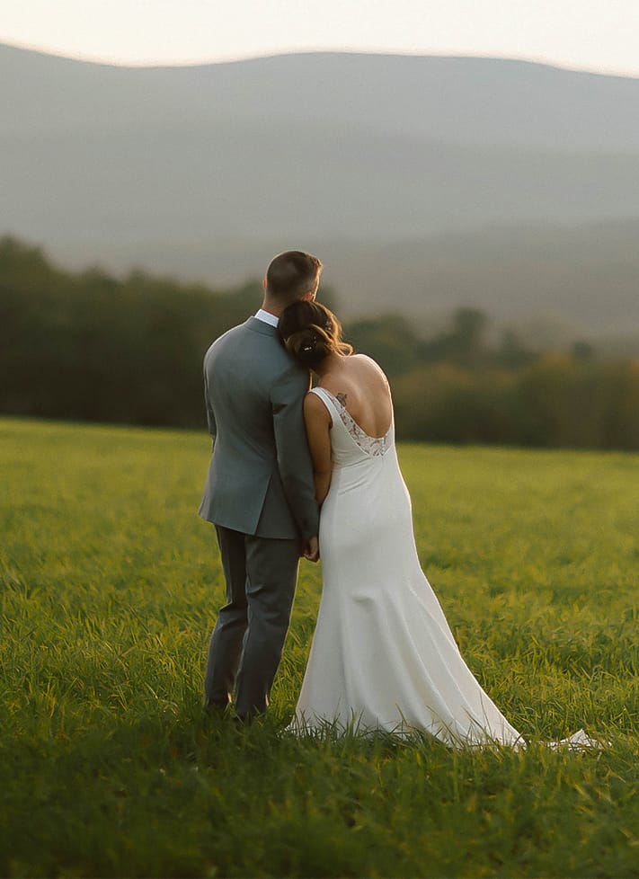 A man and woman standing in a field