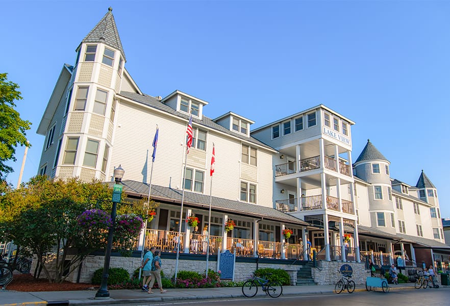 A large white building with a tower and flags