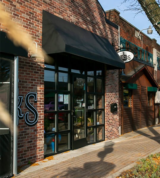 A brick building with black awnings
