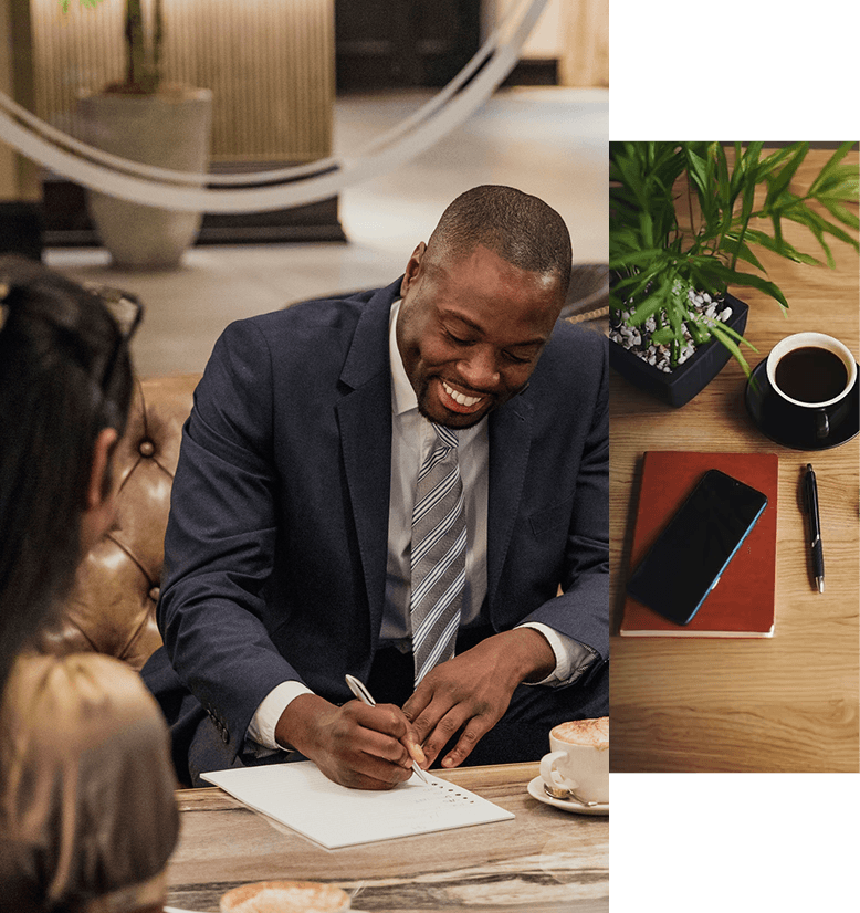 A man in a suit writing on a piece of paper